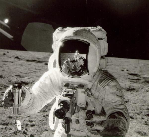 In this image, an Apollo 12 astro<em></em>naut holds a core sample inside a container. Image Credit: NASA