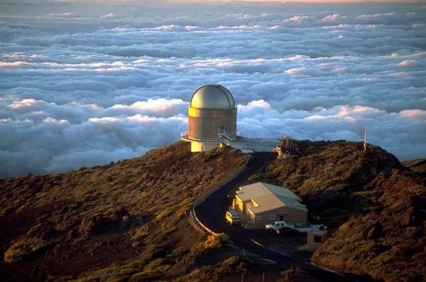 The Nordic Optical Telescope (NOT) telescope at Roque de los Muchachos Observatory in June 2001. The telescope's primary mirror is 2.56 meters but the FIES spectrograph adds to the telescope's capabilities. Image Credit: By Bob Tubbs - Own work, Public Domain, https://commons.wikimedia.org/w/index.php?curid=79707