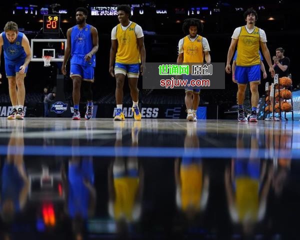 UCLA players stretch during practice for the NCAA men's college basketball tournament, Thursday, March 24, 2022, in Philadelphia.