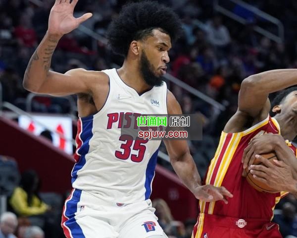 Atlanta Hawks forward De'Andre Hunter is fouled next to Detroit Pistons forward Marvin Bagley III (35) during the second half of an NBA basketball game, Wednesday, March 23, 2022, in Detroit.