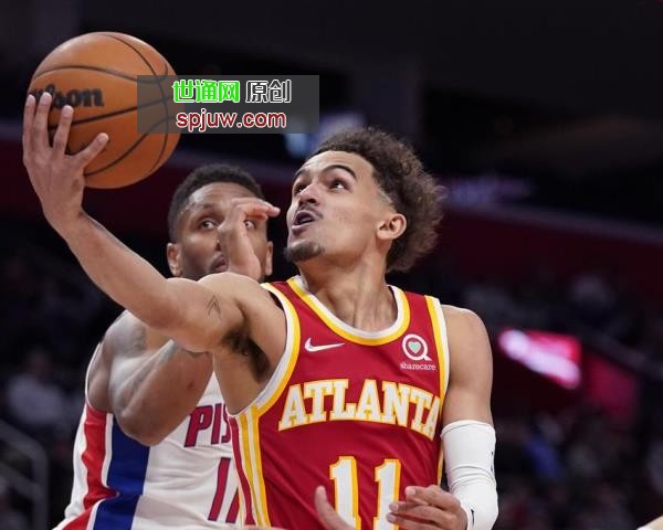 Atlanta Hawks guard Trae Young (11) makes a layup as Detroit Pistons guard Rodney McGruder defends during the second half of an NBA basketball game, Wednesday, March 23, 2022, in Detroit.