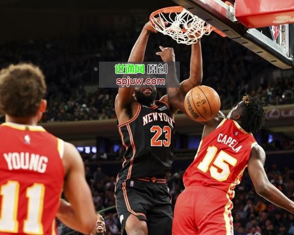 New York Knicks center Mitchell Robinson (23) dunks over Atlanta Hawks center Clint Capela (15) as guard Trae Young (11) looks on during the second half of an NBA basketball game, Tuesday, March 22, 2022, in New York.