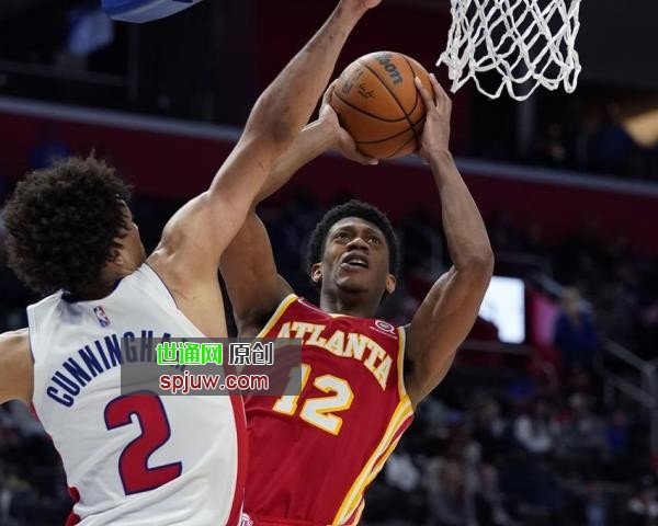 Atlanta Hawks forward De'Andre Hunter (12) shoots as Detroit Pistons guard Cade Cunningham (2) defends during the second half of an NBA basketball game, Wednesday, March 23, 2022, in Detroit.