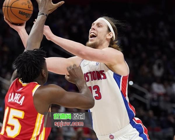 Detroit Pistons forward Kelly Olynyk (13) shoots over the defense of Atlanta Hawks center Clint Capela (15) during the first half of an NBA basketball game, Wednesday, March 23, 2022, in Detroit.