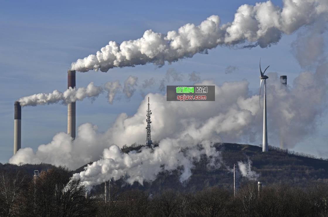 A Uniper energy company coal-fired power plant and a BP refinery are seen beside a wind generator in Gelsenkirchen, Germany, Jan. 16, 2020. (AP Photo)
