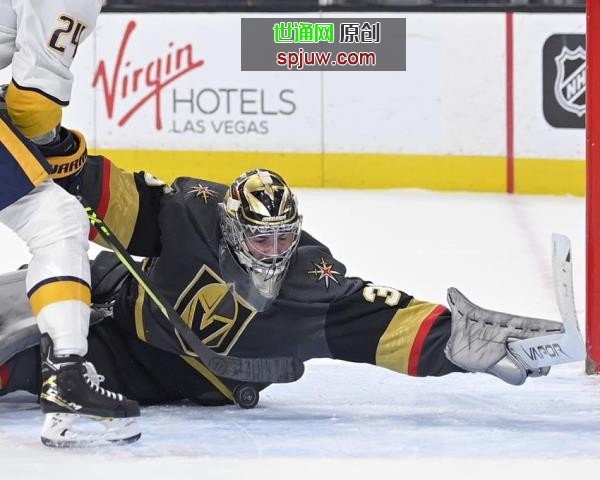Vegas Golden Knights goaltender Logan Thompson (36) makes a save against the Nashville Predators during the first period of an NHL hockey game Thursday, March 24, 2022, in Las Vegas.