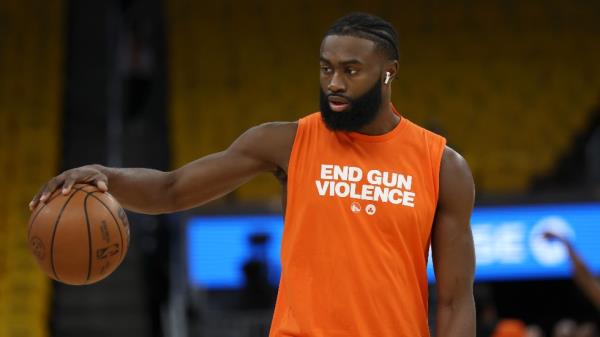 Boston Celtics guard Jaylen Brown wears a shirt that reads End Gun Violence while warming up before Game 2 of basketball's NBA Finals against the Golden State Warriors in San Francisco